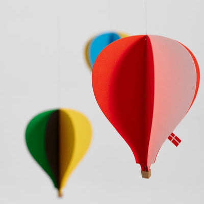Colorful hot air balloon-shaped decorations on a white background